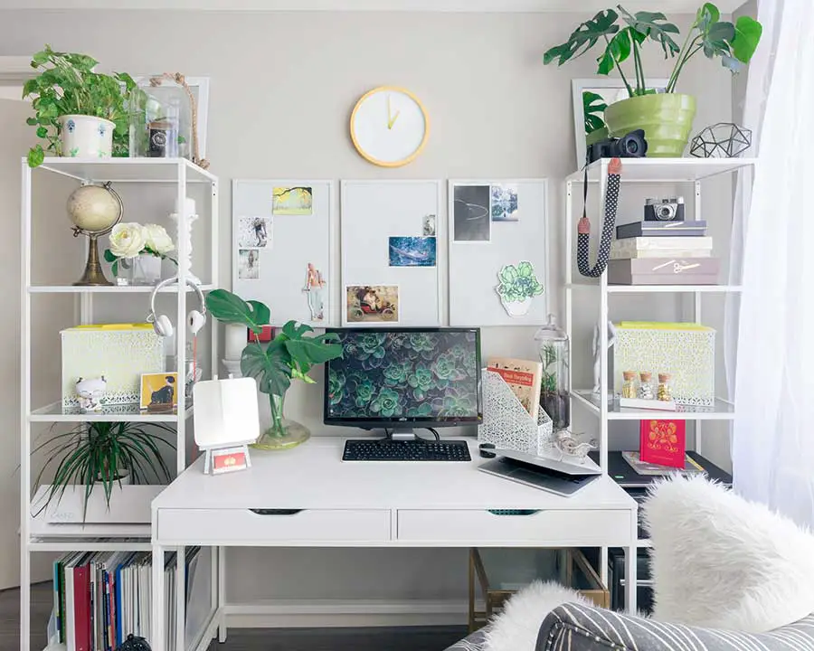 home office layout with white desk and plants