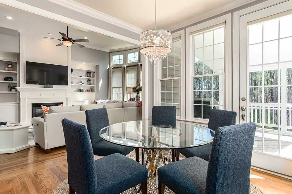 sunny room with rounded table, TV and large sofa