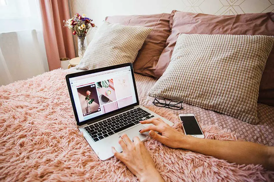 Iphone and macbook on the bed.