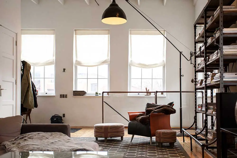 Bright room with dark furniture, white wall and sunlight.