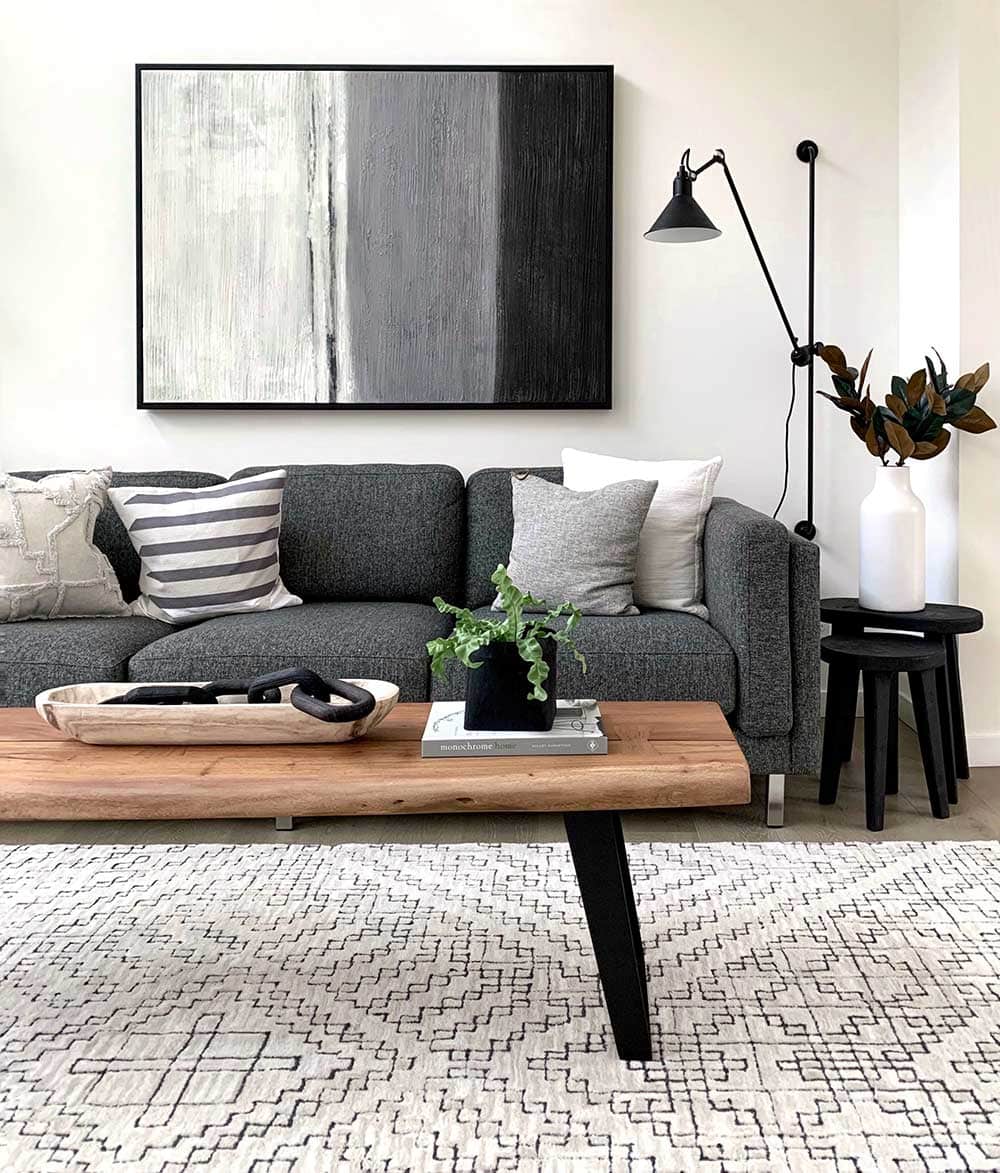 Dark gray sofa and white pattern area rug in the living room.