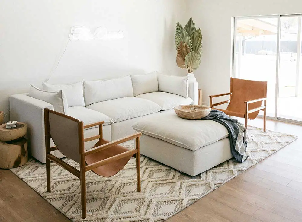 Living room seating arrangement with sofa and two accent chairs.