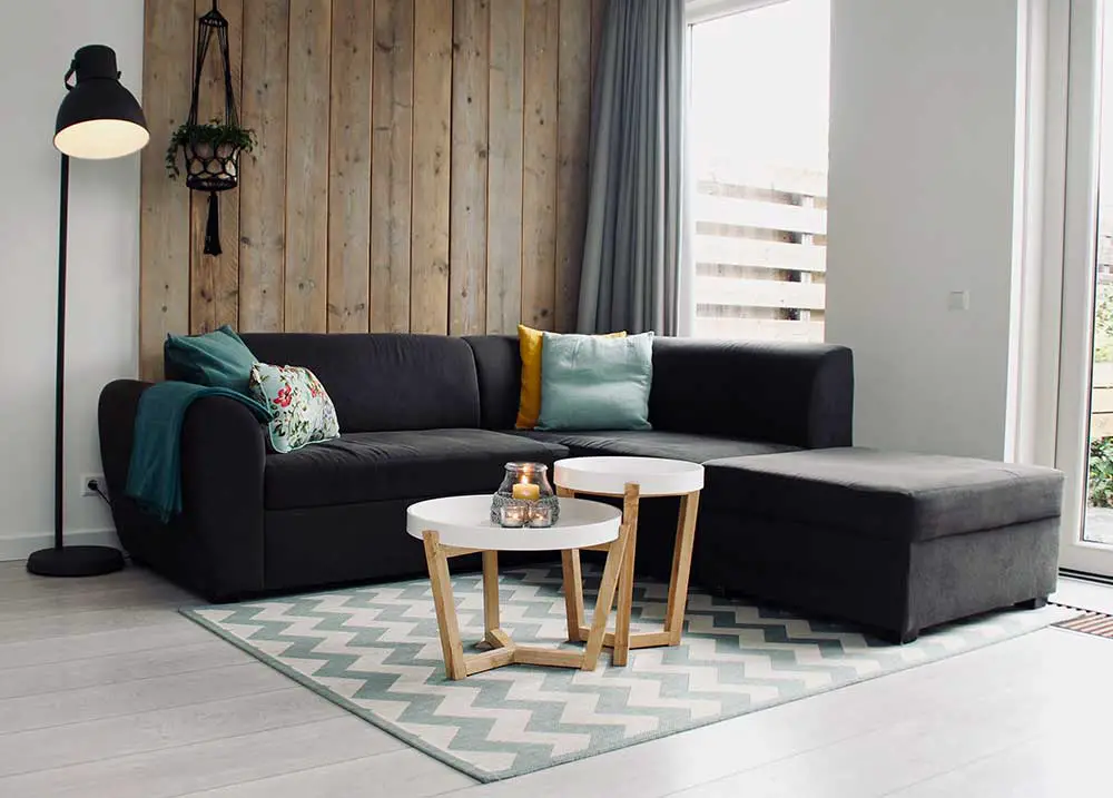 Dark color sectional sofa arranged in the corner of the room.