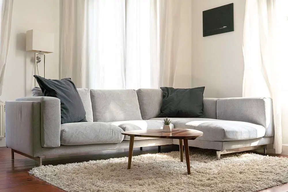 Soft color sectional sofa with coffee table.