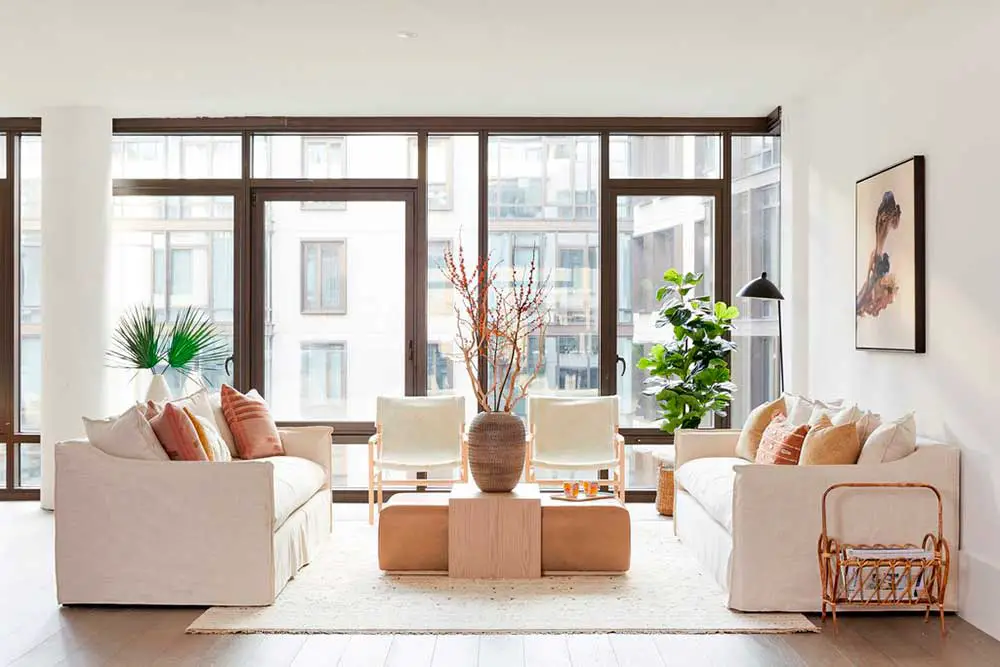 Face to face living room seating arrangement with ottoman coffee table.